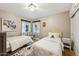 Cozy bedroom with two beds, neutral walls, bright lighting, and stylish decor and a cowhide rug at 4130 N 4Th Ave, Phoenix, AZ 85013