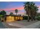 Inviting single-story home with a carport, desert landscaping, and a serene, colorful dusk backdrop at 4130 N 4Th Ave, Phoenix, AZ 85013