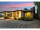 Charming home exterior featuring a stone facade, desert landscaping, and illuminated accents at 4130 N 4Th Ave, Phoenix, AZ 85013
