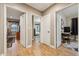 Hallway showing access to three bedrooms, wood floors, and natural light at 4130 N 4Th Ave, Phoenix, AZ 85013