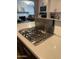 Modern kitchen features a cooktop island and views of the living room fireplace at 4130 N 4Th Ave, Phoenix, AZ 85013