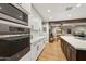 Modern kitchen with custom white cabinets and wood-look tile flooring at 4130 N 4Th Ave, Phoenix, AZ 85013
