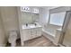 Bathroom featuring a double sink vanity, shower and tub at 4908 N 110Th Dr, Phoenix, AZ 85037