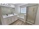 Bathroom featuring a double sink vanity, shower and tub at 4908 N 110Th Dr, Phoenix, AZ 85037