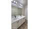 Modern bathroom featuring double sinks, quartz counters and stylish black hardware at 4908 N 110Th Dr, Phoenix, AZ 85037
