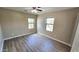 Sunlit bedroom with wood-look floors and two windows, creating a welcoming space at 4908 N 110Th Dr, Phoenix, AZ 85037