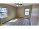 Bright bedroom featuring plank floors, ceiling fan, and large windows at 4908 N 110Th Dr, Phoenix, AZ 85037