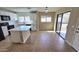 Bright eat-in kitchen with a view of a fenced backyard through sliding glass doors at 4908 N 110Th Dr, Phoenix, AZ 85037