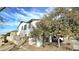Charming stucco two-story home featuring a well-manicured gravel yard and a partially obscured truck in the driveway at 4908 N 110Th Dr, Phoenix, AZ 85037