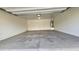A spacious two car garage featuring light-colored walls, concrete floors, and a hot water heater at 4908 N 110Th Dr, Phoenix, AZ 85037
