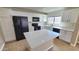 Kitchen showcasing modern appliances, white cabinets, an island, and lots of counter space at 4908 N 110Th Dr, Phoenix, AZ 85037