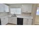 Kitchen area with white cabinets and quartz countertops, and a stainless steel sink at 4908 N 110Th Dr, Phoenix, AZ 85037