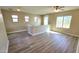 Bright living room with multiple windows, wood-look floors and a ceiling fan at 4908 N 110Th Dr, Phoenix, AZ 85037