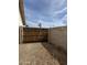 Fenced backyard with gravel, providing privacy and potential for landscaping or outdoor activities at 5430 N 74Th Ave, Glendale, AZ 85303