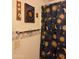 The bathroom boasts a decorative shower curtain and unique wall art at 5430 N 74Th Ave, Glendale, AZ 85303