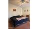 Relaxing bedroom featuring a ceiling fan, comfortable bed, and unique wall decor at 5430 N 74Th Ave, Glendale, AZ 85303