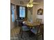 Cozy dining area with a round wooden table, seating for four, and natural light at 5430 N 74Th Ave, Glendale, AZ 85303