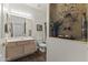 Bathroom with light wood cabinets, modern fixtures, and decorative shelving with accent lighting at 5450 E Mclellan Rd # 102, Mesa, AZ 85205