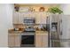 A modern kitchen with stainless steel appliances, light wooden cabinets, and stylish decor at 5450 E Mclellan Rd # 102, Mesa, AZ 85205