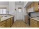 Efficient kitchen layout with wood cabinets, neutral countertops, and access to the laundry area at 5450 E Mclellan Rd # 102, Mesa, AZ 85205