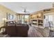 Cozy living space with a leather sofa, media center, and sliding glass doors to a patio at 5450 E Mclellan Rd # 102, Mesa, AZ 85205