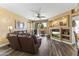Comfortable living room featuring a plush leather sofa, built-in entertainment center, and patio access at 5450 E Mclellan Rd # 102, Mesa, AZ 85205