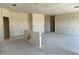 Large great room under construction has recessed ceiling lights and an island being installed at 5639 W Summerside Rd, Laveen, AZ 85339