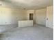Large great room still under construction features an island in the middle and recessed ceiling lights at 5639 W Summerside Rd, Laveen, AZ 85339