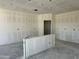 Kitchen area shows unfinished drywall, a concrete floor, and an island being installed at 5639 W Summerside Rd, Laveen, AZ 85339