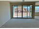 Spacious living room with expansive sliding glass doors offering stunning views of the outdoors at 5639 W Summerside Rd, Laveen, AZ 85339
