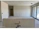Large living room under construction has an island being installed and sliding glass doors to the outside at 5639 W Summerside Rd, Laveen, AZ 85339
