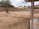 Backyard with dirt, block wall, small tree, patio, and pergola at 5684 S 237Th Dr, Buckeye, AZ 85326