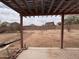 Large backyard with a pergola, block wall, dirt, brick border, and patio at 5684 S 237Th Dr, Buckeye, AZ 85326