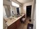 Large bathroom with dual sinks, vanity, and separate shower and closet areas at 5684 S 237Th Dr, Buckeye, AZ 85326