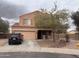 Two-story home featuring a two-car garage, neutral stucco, and low-maintenance desert landscaping at 5684 S 237Th Dr, Buckeye, AZ 85326