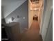 Upstairs hallway with carpet and access to bedroom, bathroom, and closet at 5684 S 237Th Dr, Buckeye, AZ 85326