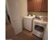Functional laundry area with a white washer and dryer at 5684 S 237Th Dr, Buckeye, AZ 85326