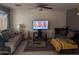 Comfortable living room with multiple seating areas, neutral walls, and a ceiling fan at 5684 S 237Th Dr, Buckeye, AZ 85326