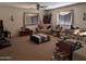 Large living room with comfortable furniture, neutral tones, and natural light at 5684 S 237Th Dr, Buckeye, AZ 85326
