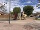 Community playground with slide and play structure near homes and sidewalk at 5684 S 237Th Dr, Buckeye, AZ 85326