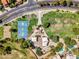 Bird's-eye view of a community park with a basketball court, playground, picnic area, and lush landscaping at 6704 W Topeka Dr, Glendale, AZ 85308