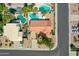 Aerial view of a house with a red tile roof and a private pool in the backyard at 6704 W Topeka Dr, Glendale, AZ 85308
