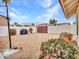 Spacious backyard with a gravel ground cover, mature landscaping, and an umbrella stand at 6704 W Topeka Dr, Glendale, AZ 85308