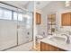 Bathroom featuring dual sinks, a shower and a toilet at 6704 W Topeka Dr, Glendale, AZ 85308