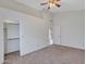 Bedroom featuring neutral carpet, ceiling fan, and closet at 6704 W Topeka Dr, Glendale, AZ 85308