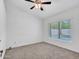 Cozy bedroom with neutral carpet, ceiling fan, and sunlit window view of the backyard pool at 6704 W Topeka Dr, Glendale, AZ 85308