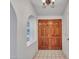 Foyer showcases a tiled floor, a view into other rooms through arched entryways, and double front doors at 6704 W Topeka Dr, Glendale, AZ 85308