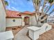Inviting front entrance with a walkway leading to a wooden door, complemented by desert landscaping at 6704 W Topeka Dr, Glendale, AZ 85308