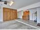 Well-organized garage featuring built-in storage, counter workspace, and bright lighting at 6704 W Topeka Dr, Glendale, AZ 85308