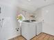 Bright laundry area with a whimsical stained glass window, washer, dryer, and tile flooring at 6704 W Topeka Dr, Glendale, AZ 85308